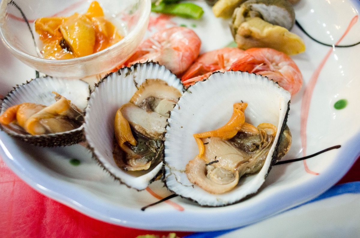 Okinawan seafood market with fresh fish and grilled octopus