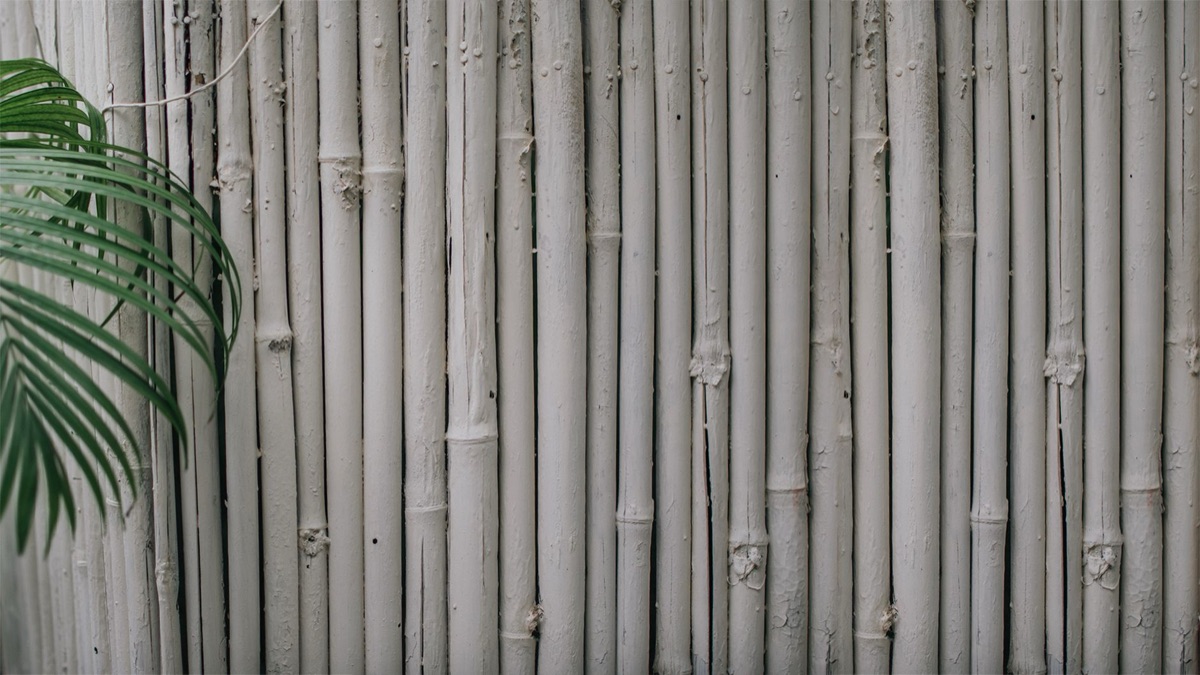 okinawan ryokan exterior with bamboo fence and stone pathway