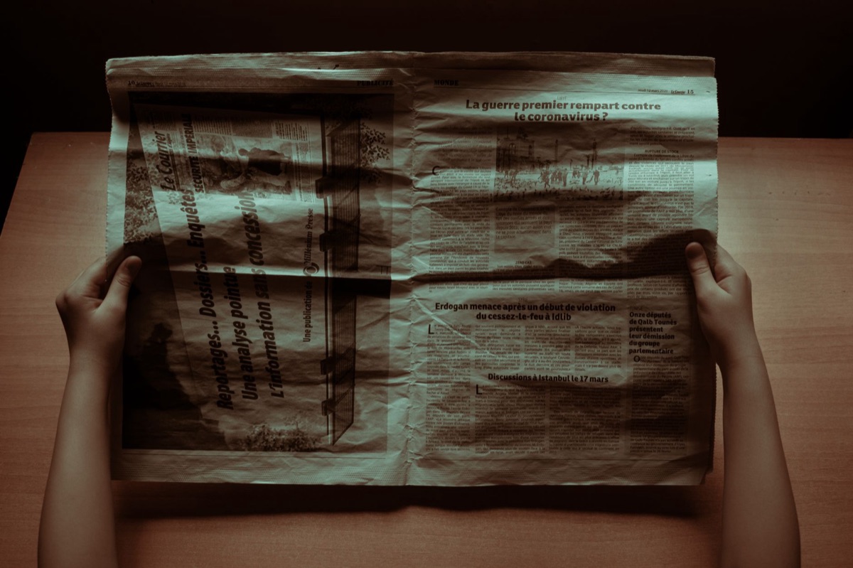 old newspaper article with war photographs